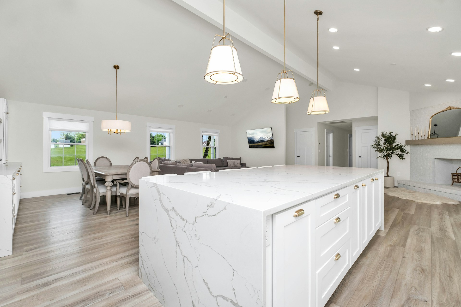 White kitchen island and wood stools, shown as stock design inspiration